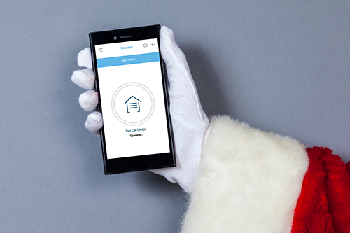 santa claus holding a smart phone with smart garage app